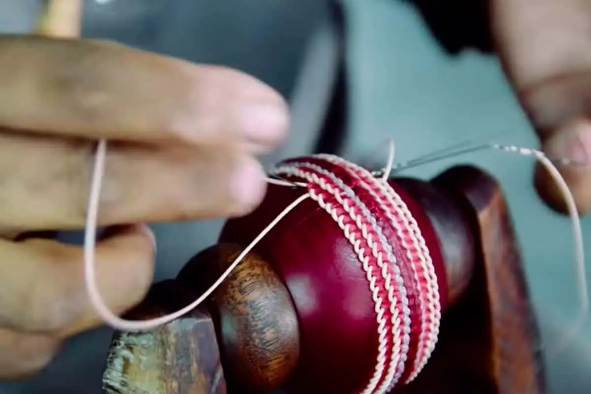 Final stitching of a cricket ball